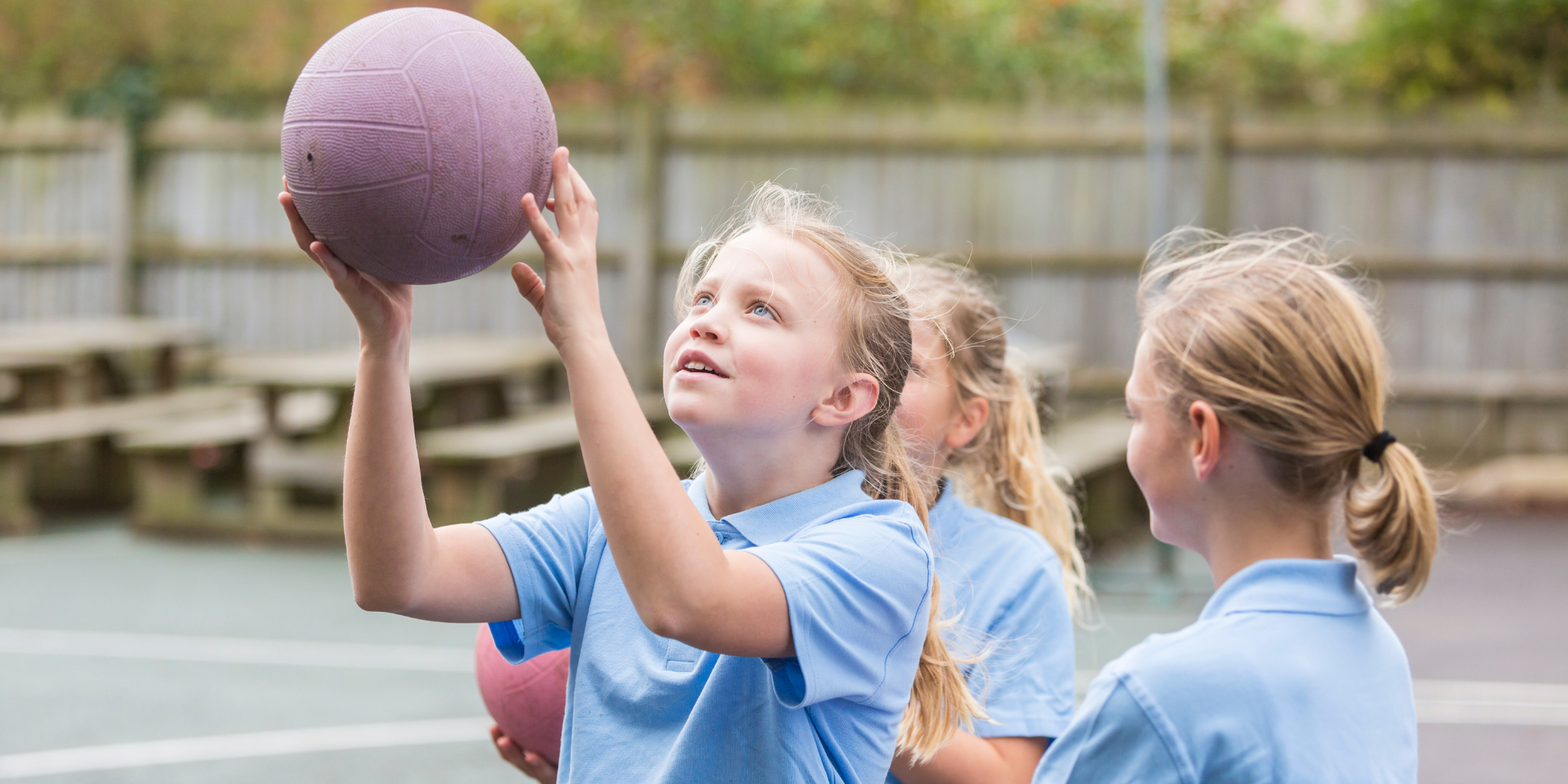 Young children playing netball.