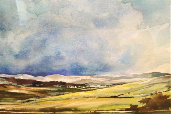 A watercolour painting which shows green, open countryside leading to hills in the background under a blue sky dotted with white clouds